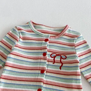 Baby girl striped knit cardigan detail, cute button-up autumn baby sweater with bow accent.