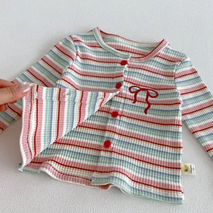 Baby girl striped knit cardigan detail, soft cotton fabric, single-breasted buttons.