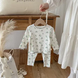 Kids floral pajama set detail, long sleeve top and pants, cozy cotton homewear for autumn girls.