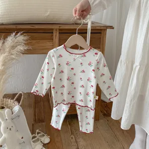 Children autumn floral pajama set detail, long sleeve top and pants with cute red lettuce edge trim.
