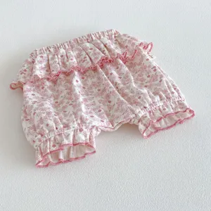 Detailed view of cute baby girl floral bloomers with cute ruffled lettuce edge design.