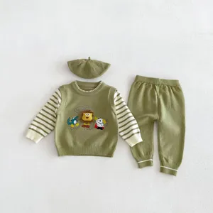 Detailed view of kids knitted three-piece set, featuring cute cartoon animals and soft fabric.