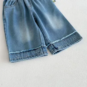Girls cute blue denim shorts with white heart embroidery and raw hem. Comfortable elastic waist casual pants.