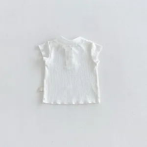 White ribbed baby t-shirt detail showing cute ruffle collar and soft short sleeve infant top.