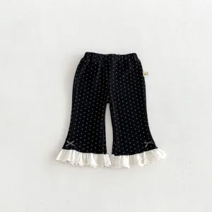 Toddler girls black polka dot flared pants with cute white lace ruffle hem and sweet bows.