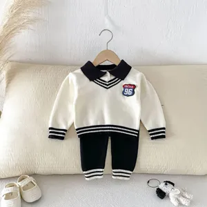 Toddler boys knitwear set featuring white collared sweater and black pants with chic vintage patch.