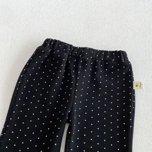 Toddler black polka dot pants detail view, elastic waist comfortable casual kids wear.