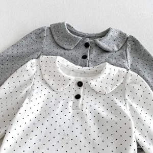 Infant baby girl long sleeve top detail showing cute doll collar and black polka dot pattern.