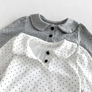 Infant cotton long sleeve top with cute doll collar and classic polka dot pattern detail.