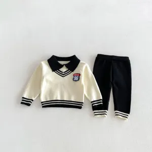Detail view of the toddler knit sweater set, featuring contrasting polo collar and long pants.