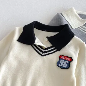 Close up detail of kids autumn knitted polo sweater with contrast collar and vintage badge.