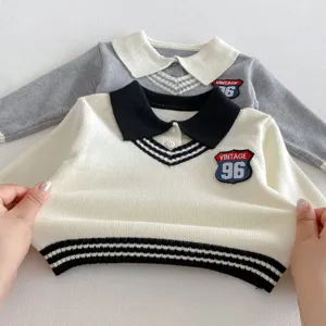 Detailed closeup of kids knitted sweater showing stretchy fabric, lapel collar, and vintage patch.