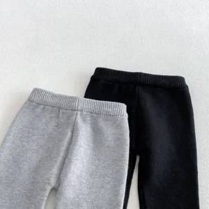 Close-up detail of baby knitted pants, soft ribbed cuffs, solid color design, cozy.