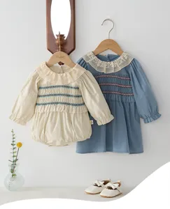 Cute spring baby girl long sleeve smocked romper and dress set with elegant lace collar.