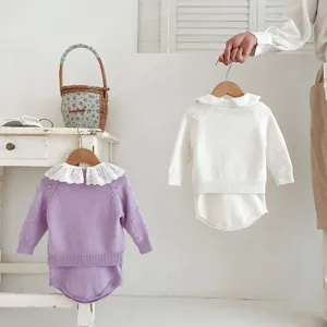 Infant baby knit sweater romper set detail, cute lace collar and soft cotton knit fabric.