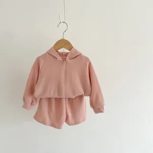 Baby pink waffle knit hooded jacket and shorts two-piece set for infants, detail view.