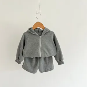 Close-up detail of gray infant waffle knit zip hoodie and shorts set, soft cotton texture.