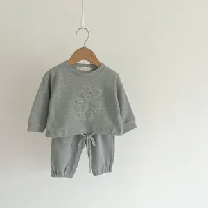 Close-up details of baby waffle knit sweatshirt lounge set, cozy texture and elastic cuffs.
