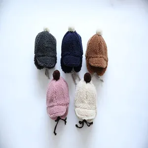 Infant plush trapper hat detail showing cute furry fabric, warm earflaps, and lovely pompom design.