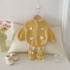 Detailed view of baby girls spring knit sweater and leggings set with 3D white heart decor.