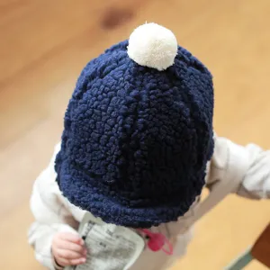 Infant winter fleece hat detail, cozy teddy plush material with cute white pom pom top, warm earflap design.