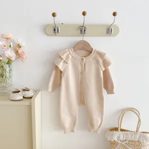 Detail of beige infant knit baby romper, cute ruffle shoulder design for newborn autumn wear.