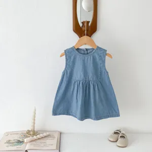 Infant denim sleeveless dress detail, soft fabric texture, lifestyle hanging shot setup.