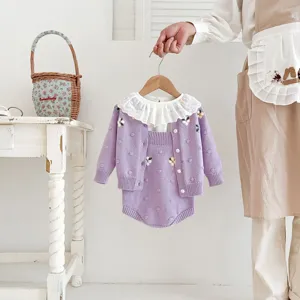 Detail view of infant baby girl purple knit cardigan set with handmade floral embroidery.