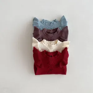 Detail shot of cute baby knitted sweaters with fly sleeves and lace ruffles in four colors.
