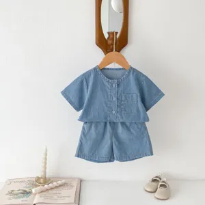 Close-up detail view of the infant denim short sleeve shirt and shorts set with wooden buttons.