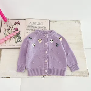 Infant baby girl knitted cardigan sweater with handmade floral embroidery and cute dots.