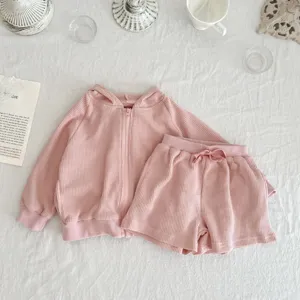 Pink baby waffle knit hooded jacket and shorts set, detail view of casual toddler clothing.