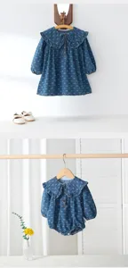 Baby girls denim dress and romper set featuring cute ruffle collar and bow print. Detail view.