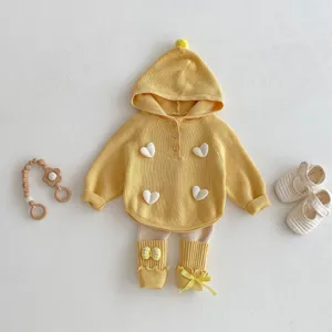 Detail view of cute girls spring knit hooded sweater with 3D hearts and leggings.