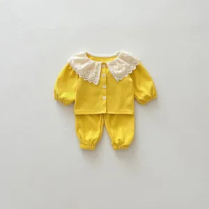 Infant baby girl waffle two-piece set featuring cute white lace collar and cozy long sleeves.