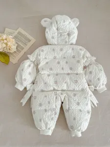 Detail of cute baby winter down romper with bear ears and floral print for warm daily wear.