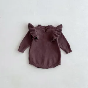 Baby knit romper detail shot, dark purple long sleeve baby sweater with cute ruffles.