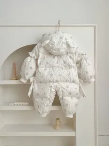 Infant winter down romper detail view, cute hooded baby snowsuit with warm white fluffy padding.
