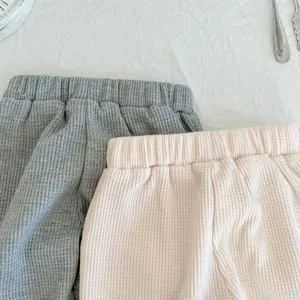 Toddler waffle casual pants detail view, soft cotton blend fabric, elastic waistband, grey and pink.