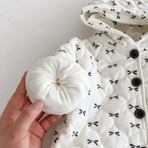 Detailed close-up showing soft quilted padding and cute bow print of baby winter jacket.
