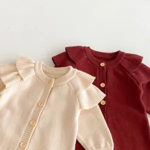 Cute baby knit romper with ruffle shoulders and wooden buttons, warm autumn infant clothing.