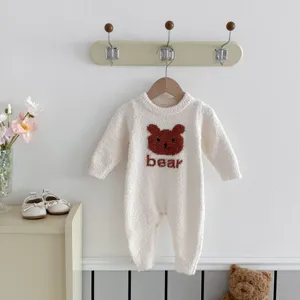 Detailed view of cozy baby plush romper featuring a cute bear pattern and long sleeves.