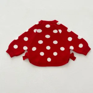 Red knit baby girl sweater featuring lovely white polka dots and side bow details for autumn.