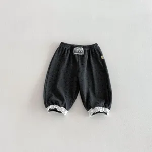 Toddler girl casual bloomers detail, dark grey cotton pants with white lace cuffs.