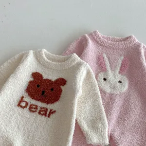 Cute baby plush romper detail featuring cozy bear and bunny knit patterns for winter.