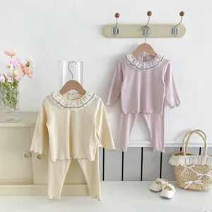 Detail view of cute baby girl autumn two-piece set with lace doll collar and ribbed knit design.