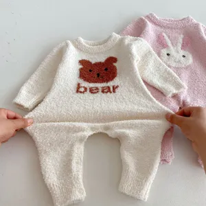 Detailed close-up view of thick soft baby rompers featuring cute bear and rabbit patterns.