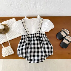 Infant baby girl summer white ruffle blouse with black white plaid suspender shorts outfit.