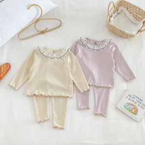 Detail shot of cute baby girl autumn long sleeve ribbed top and leggings set with sweet doll collar.