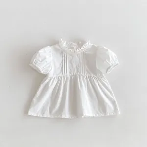 Cute white baby girl short sleeve blouse with sweet ruffles and pleated front details.